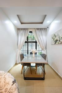 a dining room with a table and a window at Garden Ridge in Abuja