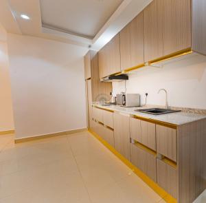 a kitchen with wooden cabinets and a counter top at Garden Ridge in Abuja