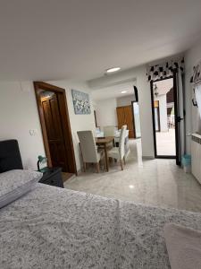 a bedroom with a table and chairs and a dining room at Rooms Vesna in Salopek-Selo
