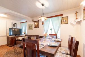 a living room with a table and a dining room at Herbal Garden Resort Plahtica in Jurklošter