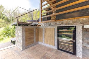 an outdoor kitchen with a balcony on a house at Herbal Garden Resort Plahtica in Jurklošter +23 photos