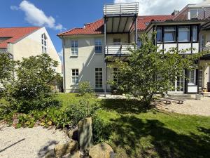 a large house with a garden in front of it at Schonekind Appartement Soest in Soest