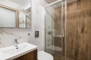 a bathroom with a shower and a toilet and a sink at D & D Apartments in Kassandra +9 photos