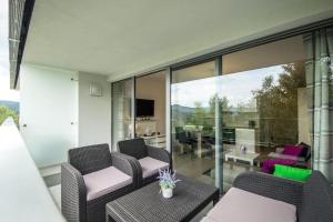a living room with two chairs and a table at Apartment Mountain Panorama in Wisła +12 photos