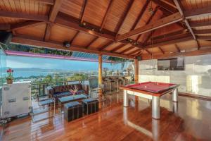 a room with a ping pong table on a deck at Luxury 4 pool Seaview 6 bedroom Villa on Surin Hill in Surin Beach