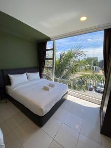 a bedroom with a bed and a large window at Hotel Double Star Klia in Sepang