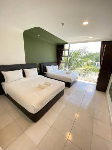 a bedroom with two beds and a large window at Hotel Double Star Klia in Sepang +86 photos