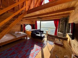 a room with a bed and a couch in a cabin at ONASUITBUNGALOW in Rize