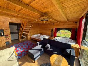 a living room with a jacuzzi tub in a cabin at ONASUITBUNGALOW in Rize
