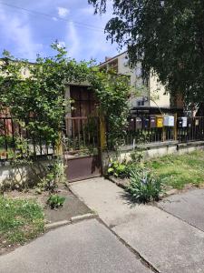 a building with a gate in front of it at B23 Apartman in Harkány