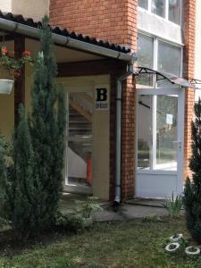 a door to a building with a b entry at B23 Apartman in Harkány +6 photos