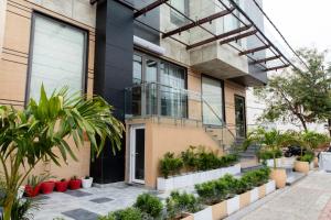 a building with plants in front of it at Hotel Avenue 30 in Lucknow