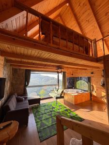 a living room with a loft bed in a cabin at ONASUITBUNGALOW in Rize +40 photos