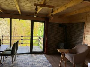 a living room with a table and chairs and a glass door at ONASUITBUNGALOW in Rize