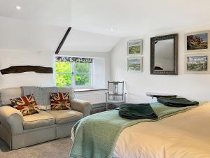 a living room with a bed and a couch at Whitley Farm Molland in Molland