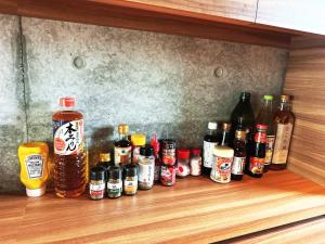 a row of bottles of alcohol on a wooden shelf at SENJA Dewata in Mitoyo