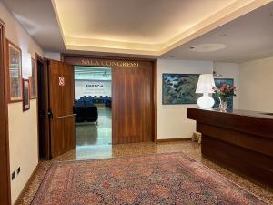 an office lobby with a sliding glass door at Hotel Piroga Padova in Selvazzano Dentro