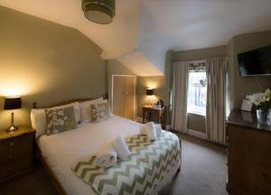 a bedroom with a large bed with towels on it at Lingmoor in Windermere