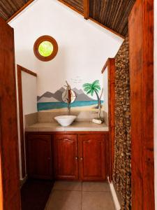 a bathroom with a sink in a room at Ny Fano Kite Lodge in Ivovona +47 photos
