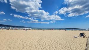 a beach with a bunch of people on it at Hotel Longosa - All Inclusive Family Hotel near the beach in the peaceful southern part of Sunny Beach in Sunny Beach