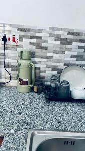 a kitchen counter with a sink and a counter top with a counter top at Osim bnb 2 in Arusha +23 photos
