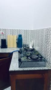 a stove top on a counter in a kitchen at Osim bnb 2 in Arusha