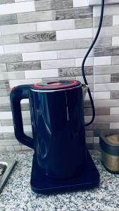 a blue tea kettle sitting on a counter at Osim bnb 2 in Arusha