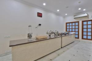 a kitchen with a counter in a room at Hotel Sarita - Near Surat Railway Station in Surat