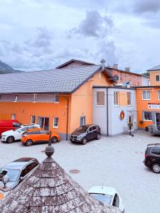 a parking lot with cars parked in front of a building at Hotel Vogelweiderhof in Salzburg