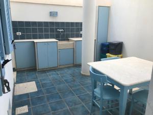 a kitchen with a table and chairs in a room at Azzurrina in Marettimo