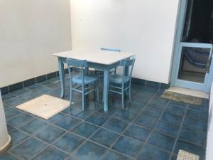 a table and chairs sitting on a tiled floor at Azzurrina in Marettimo +1 photo