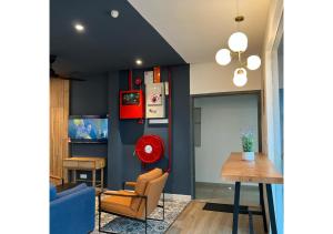 a living room with blue walls and a table and chairs at Hotel Double Star Klia in Sepang
