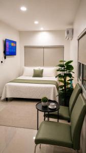 a bedroom with a bed and a table and a chair at The Onyx by 7 Valleys in Islamabad