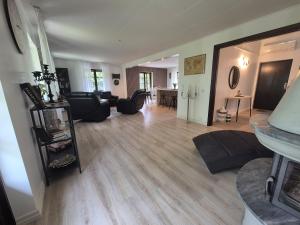 a living room with a couch and a table at Stenberg Nature Residence in Tyringe