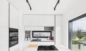 a kitchen with white cabinets and a sink at Vila Volme in Banjole