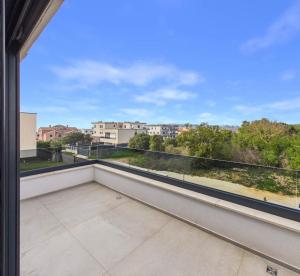 a large balcony with a view of a city at Vila Volme in Banjole