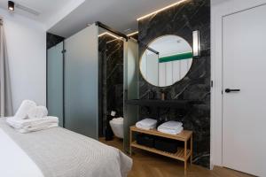 a bathroom with a bed and a mirror at CSE MS Museo Select in Seville +101 photos
