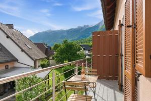 a balcony with a table and a view of mountains at Relax Bovec in Bovec