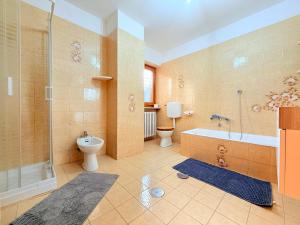 a bathroom with a tub and a toilet and a shower at Casa di Mary in Châtillon +49 photos