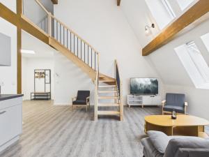 a living room with a staircase in a loft at Landeskron38 - LK38 in Görlitz