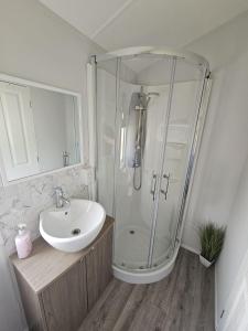 a bathroom with a shower and a sink at Bwr27 in East Mersea +11 photos
