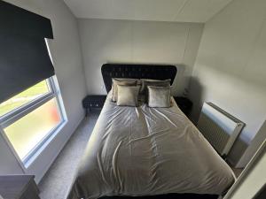 a bed with two pillows on it in a bedroom at Bwr27 in East Mersea