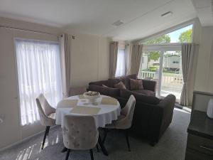 a living room with a table and a couch at Bwr27 in East Mersea