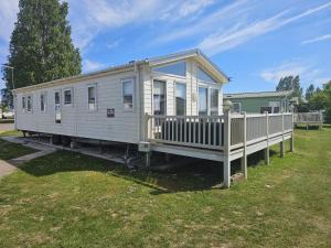 a tiny house sitting on top of a yard at Bwr27 in East Mersea