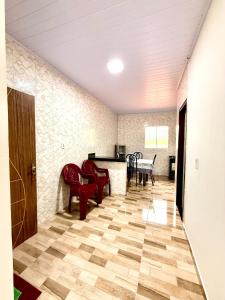 a living room with red chairs and a table at Lardunas in Santo Amaro