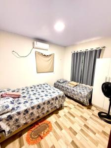 a room with two beds and a fan at Lardunas in Santo Amaro