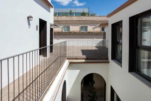 a balcony with a staircase in a building at CSE MS Museo Select in Seville