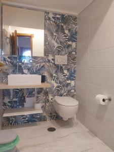 a bathroom with a toilet and a wall at Villa le Arcate in Furore +60 photos