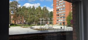 a view from a window of a park with a fountain at Studio Ap in Visaginas