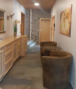 a kitchen with two chairs and a table in a room at Kurbad St Martin in Bad Kohlgrub